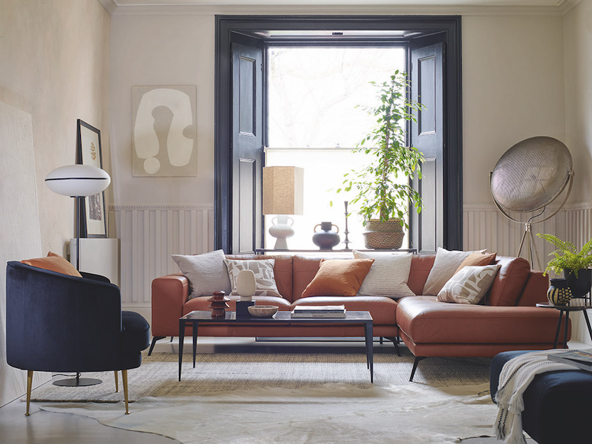 9 Perfect Pairings - Living Room Trends with DFS - Summer 2020 - DFS Nuela open ended sofa in Copper Mine Leather & DFS Enchanted Accent Chair in Black Velvet