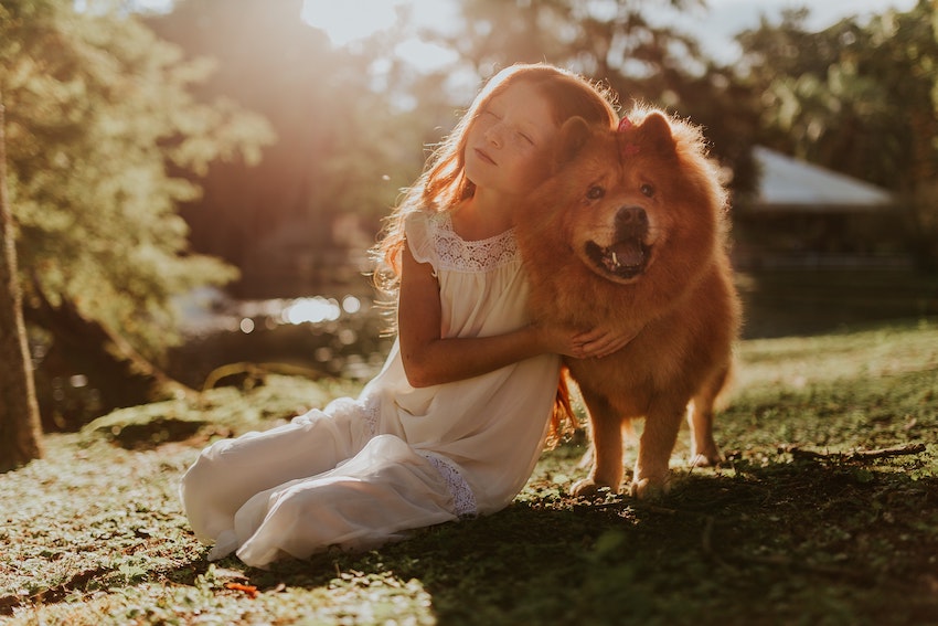6 Ways Keeping Pets Benefits Your Child - A girl hugging dog