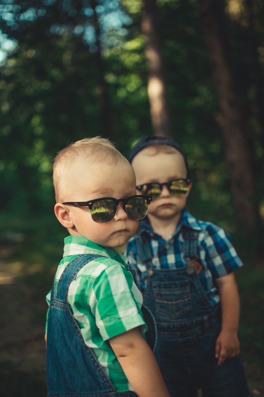 Kids Health - 10 Reasons Children Should Wear Sunglasses - Girl on bike wearing sunglasses - Little boys