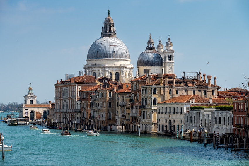 4 Must-Visit Places to Experience on a Europe Tour - View of Basilica di Santa Maria della Salute taken from Ponte dell'Accademia over Grand Canal