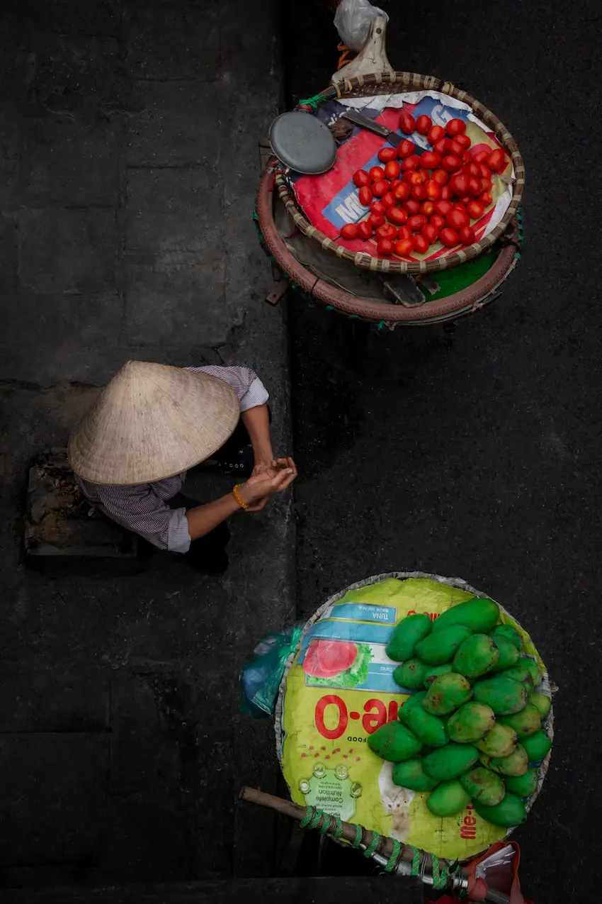 Top Business Ideas for Travel Lovers - A Complete Guide - Street Seller in Hanoi from Chuong Duong Do Street, near Hanoi's Ceramic Wall, Vietnam